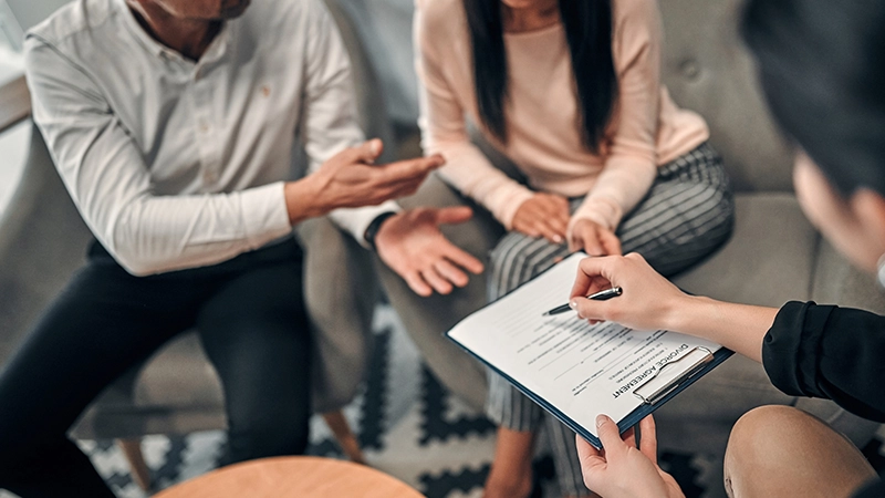 Cropped image of couple signing an agreement.